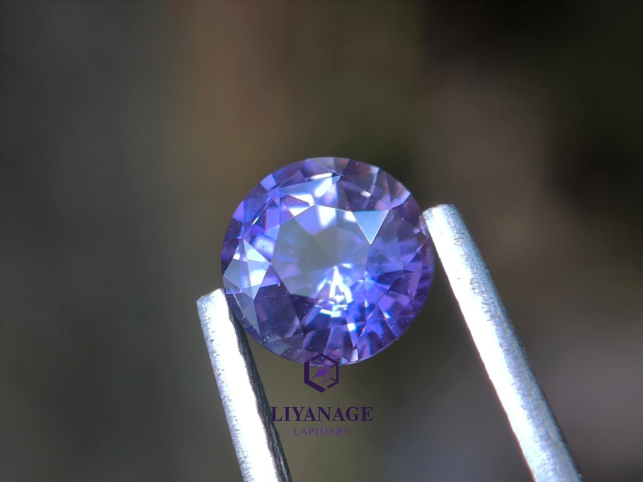 1.25 ct unheated Ceylon purple sapphire round cut with pink violet and bluish hue